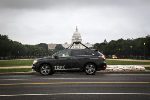 Torc vehicle driving past the Capitol building. 