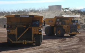 A Komatsu 930E truck (left) positioned next to a Cat 793F CMD during an autonomous mine truck demonstration at the Tinja Hills Demonstration and Learning Center. Source: Caterpillar, Inc