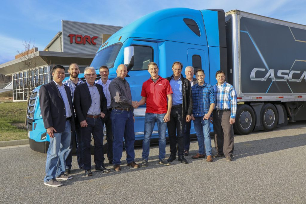 Torc and Daimler executives gathered together for a photo.