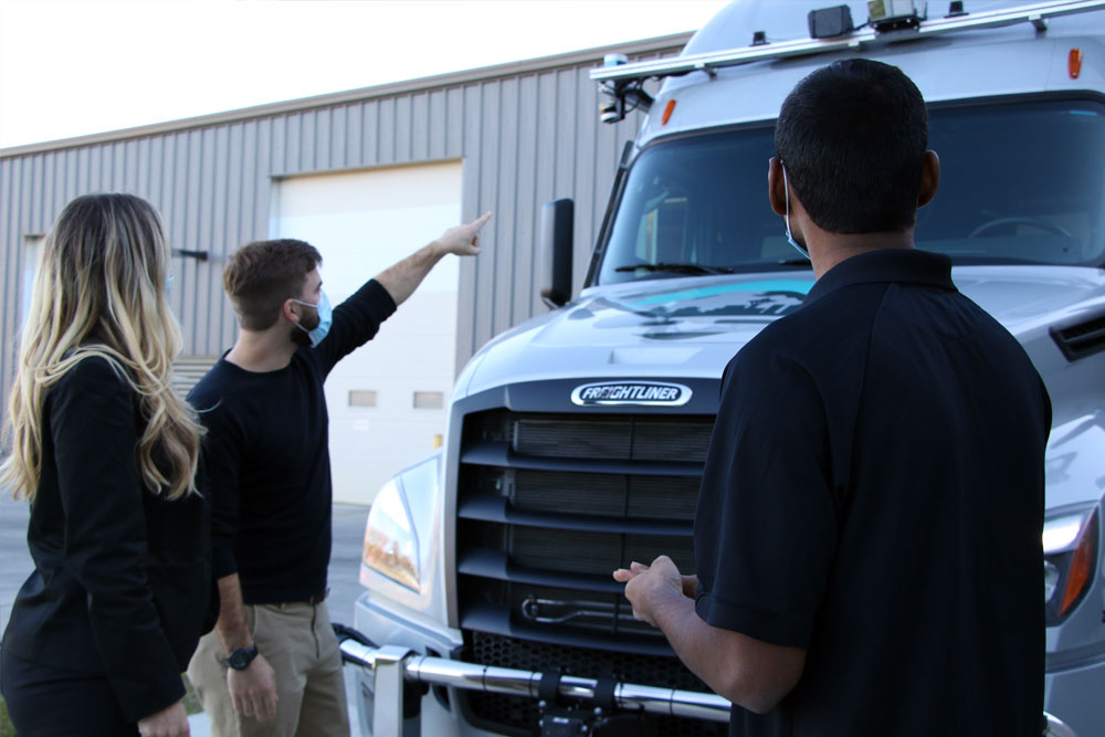 torc team members inspecting a truck.