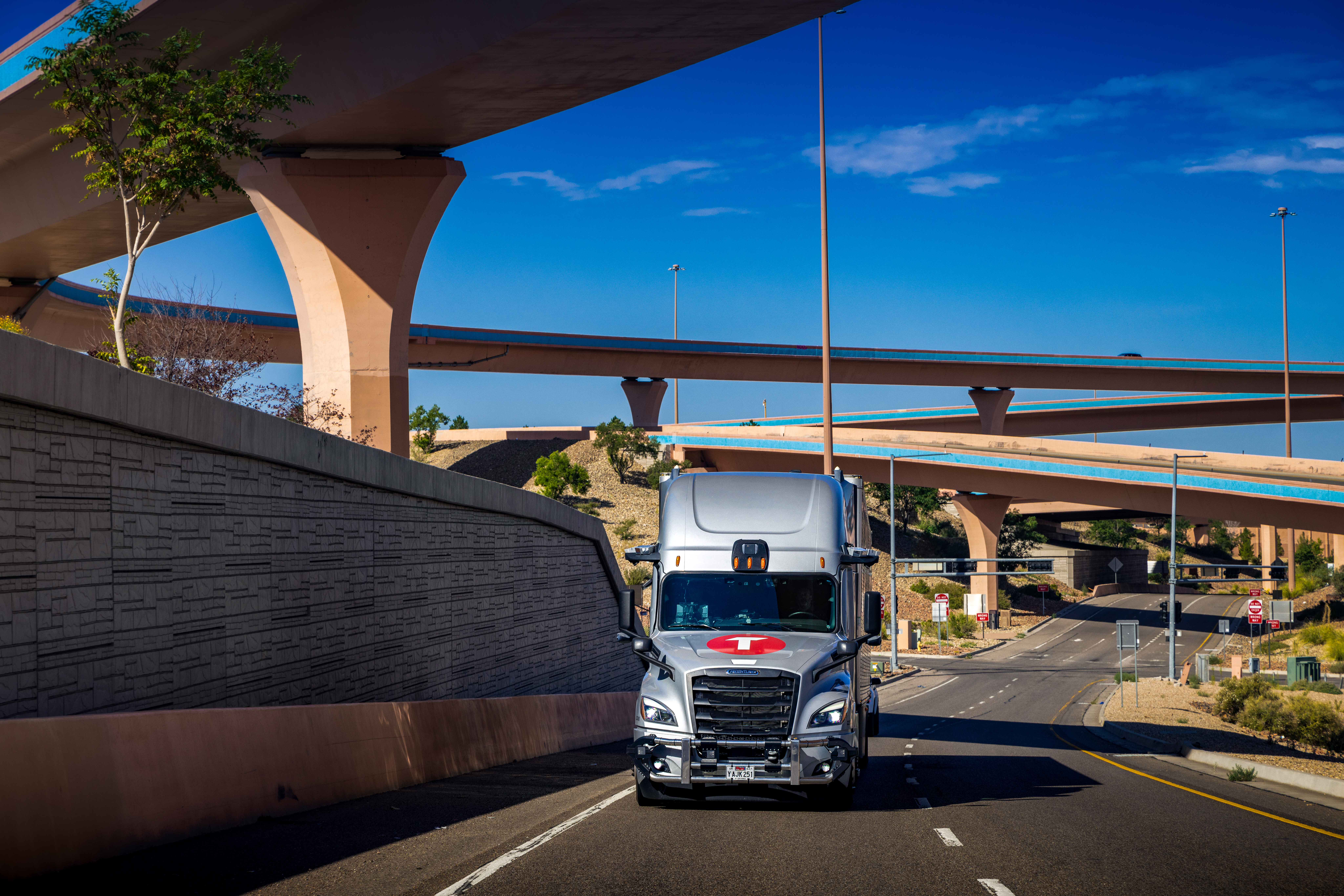 Torc autonomous truck on the highway with overpasses in New Mexico